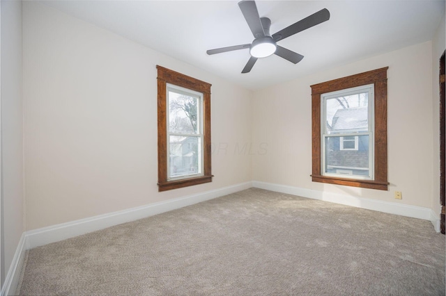 carpeted empty room featuring ceiling fan