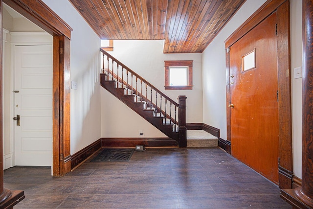 foyer featuring dark hardwood / wood-style flooring and wooden ceiling