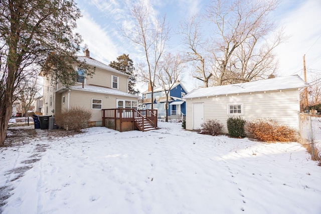 snow covered property featuring a wooden deck