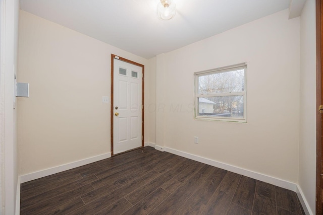 unfurnished room with dark hardwood / wood-style flooring