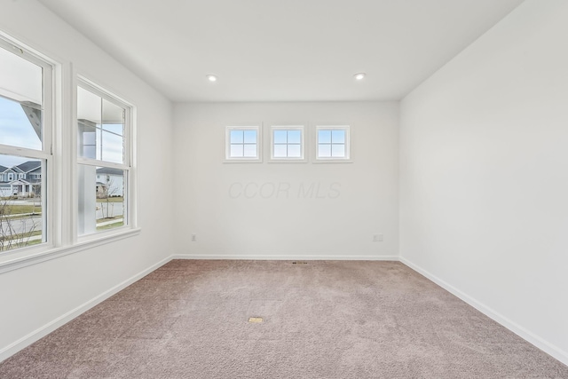 unfurnished room with plenty of natural light and carpet flooring