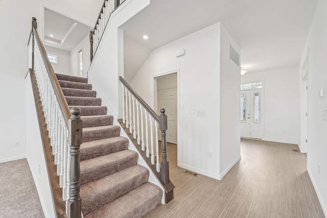 staircase with hardwood / wood-style flooring and plenty of natural light