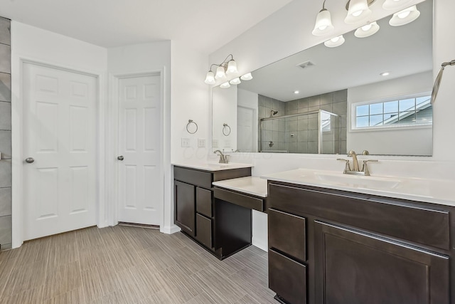 bathroom featuring vanity and a shower with door