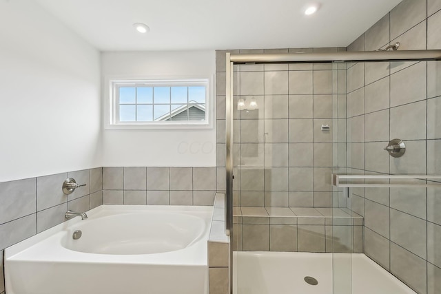 bathroom with shower with separate bathtub