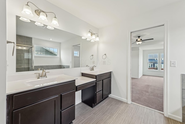 bathroom featuring a shower with door, vanity, and ceiling fan