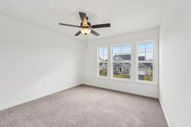 unfurnished room featuring ceiling fan and carpet floors