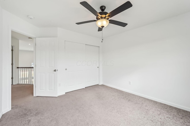 unfurnished bedroom featuring ceiling fan, carpet floors, and a closet