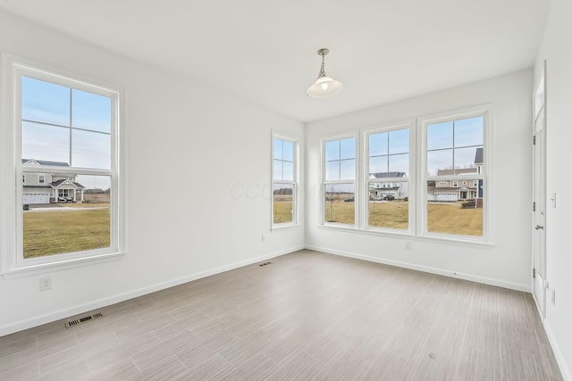 spare room with light hardwood / wood-style floors