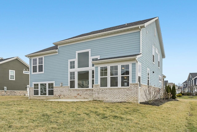 rear view of house with a yard and a patio