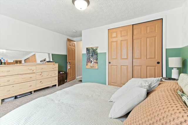 bedroom with a closet, carpet flooring, and a textured ceiling