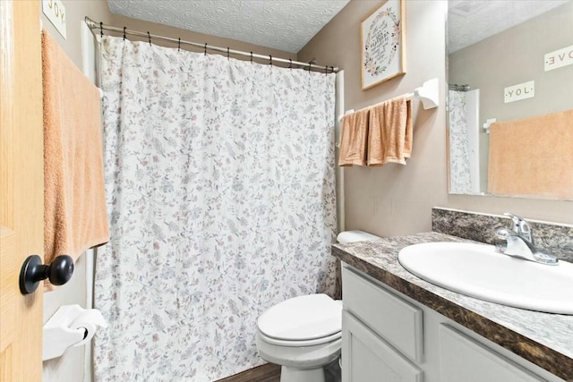 bathroom featuring toilet, hardwood / wood-style floors, a textured ceiling, and vanity