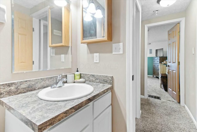 bathroom featuring a textured ceiling and vanity