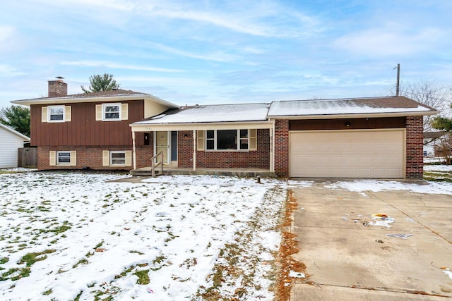 tri-level home with a garage and covered porch