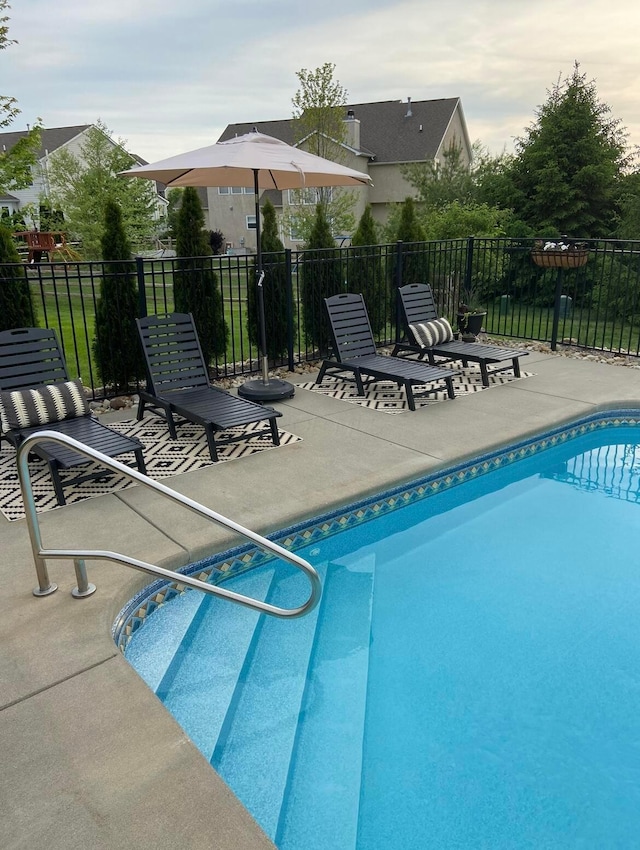 view of swimming pool featuring a patio area