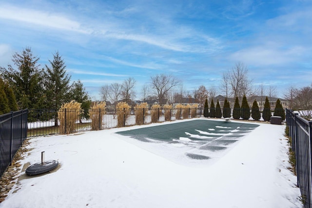 yard covered in snow with a covered pool