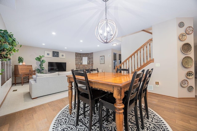 dining room with a notable chandelier and light wood-type flooring