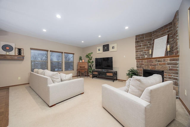 living room with a brick fireplace and carpet