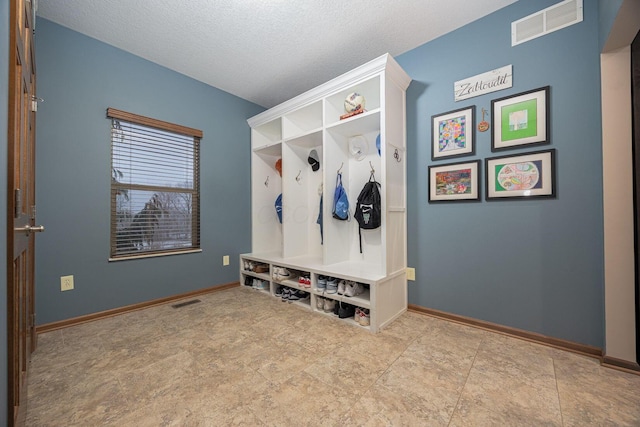 mudroom with a textured ceiling