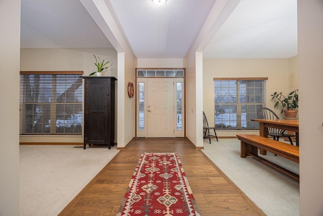 entryway featuring hardwood / wood-style floors and a textured ceiling