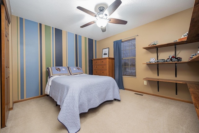 bedroom with a textured ceiling, light colored carpet, and ceiling fan