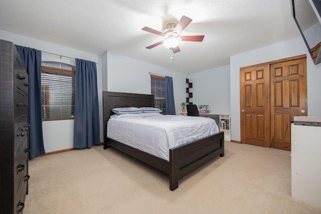 carpeted bedroom with a textured ceiling and ceiling fan