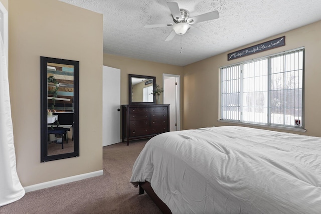 bedroom with carpet, a textured ceiling, and ceiling fan