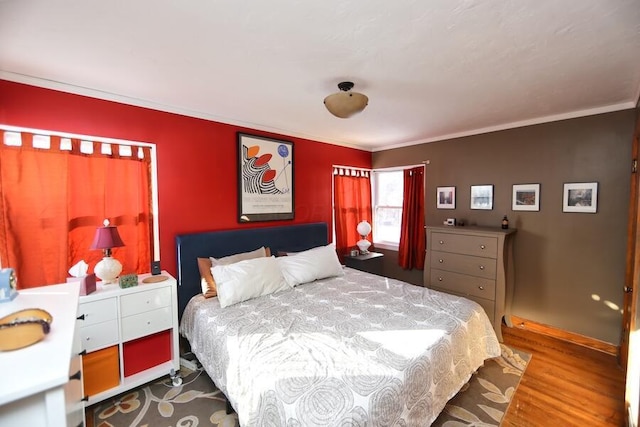 bedroom featuring hardwood / wood-style flooring and crown molding