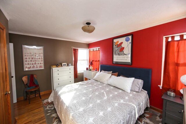 bedroom featuring ornamental molding and wood-type flooring