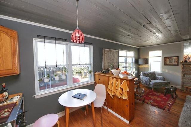 interior space with ornamental molding, dark hardwood / wood-style flooring, and wooden ceiling