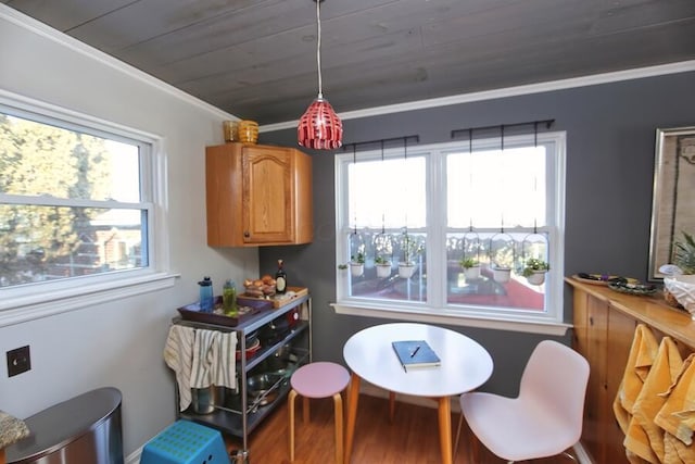 living area with wood ceiling, wood-type flooring, and crown molding