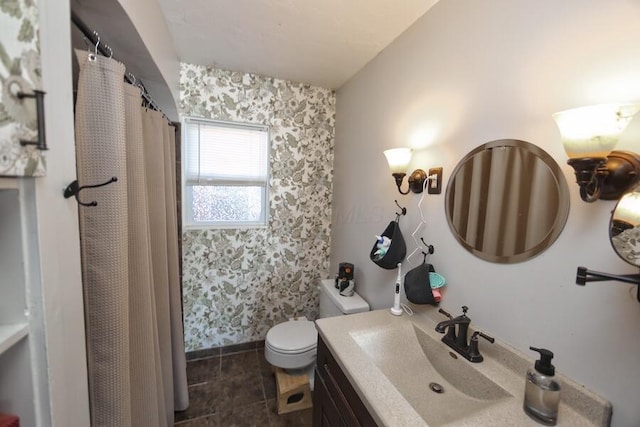 bathroom featuring walk in shower, tile patterned floors, vanity, and toilet