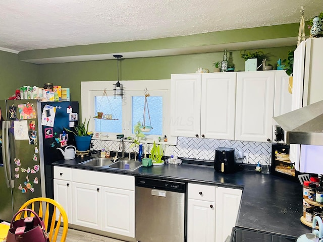 kitchen featuring sink, a textured ceiling, appliances with stainless steel finishes, and tasteful backsplash