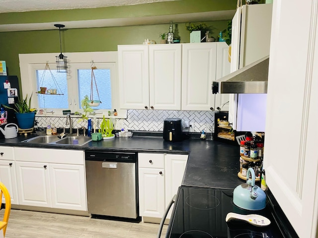 kitchen featuring sink, backsplash, white cabinets, and stainless steel dishwasher