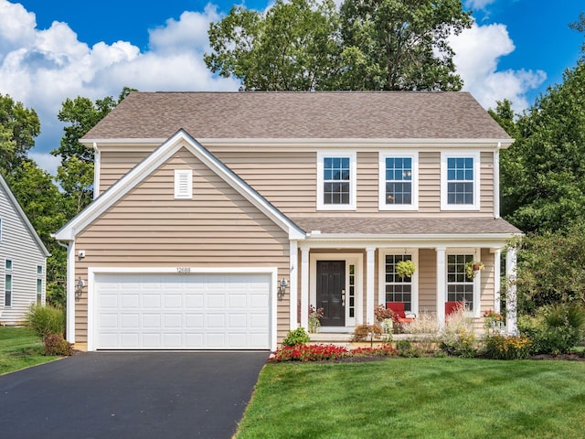 view of front of house with a front yard and a garage