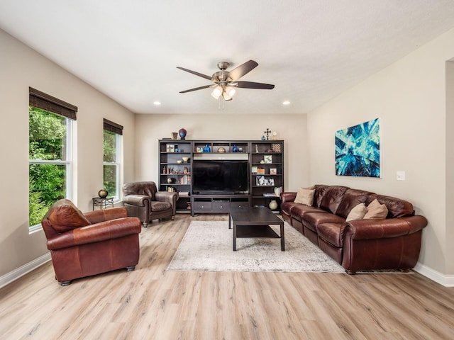 living room with light hardwood / wood-style floors and ceiling fan