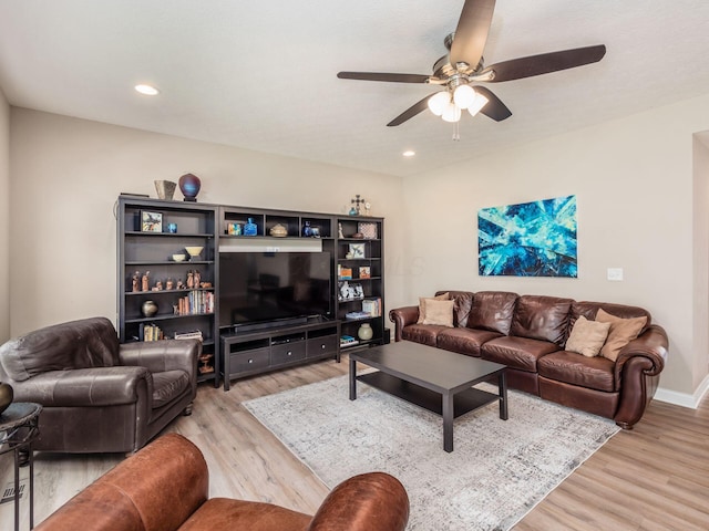 living room with ceiling fan and light wood-type flooring