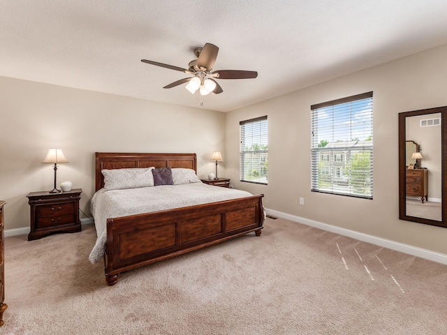 bedroom featuring ceiling fan and light carpet