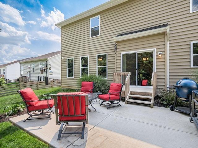 rear view of house featuring a patio area and an outdoor fire pit