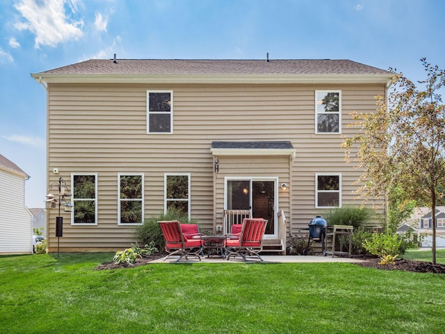 rear view of property with a lawn and a patio