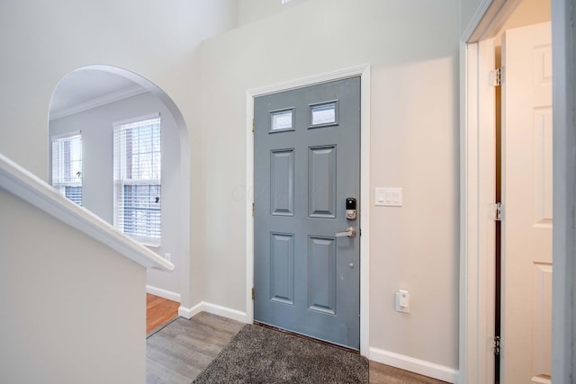 foyer entrance with hardwood / wood-style floors and ornamental molding