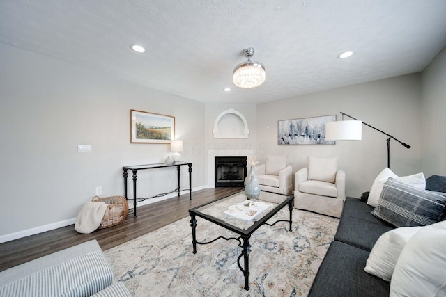 living room featuring hardwood / wood-style flooring and a textured ceiling