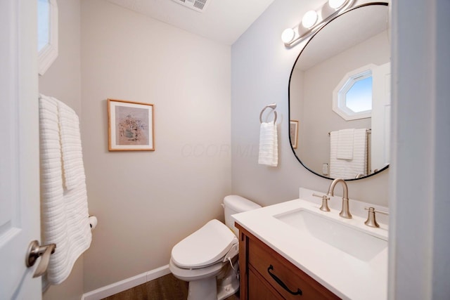 bathroom featuring hardwood / wood-style flooring, vanity, and toilet