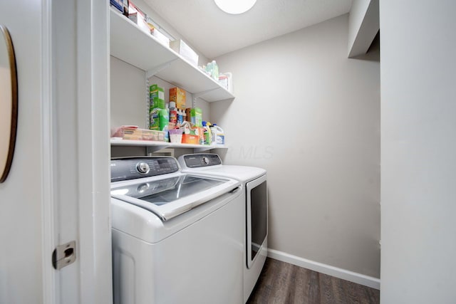 washroom featuring dark wood-type flooring and washer and clothes dryer