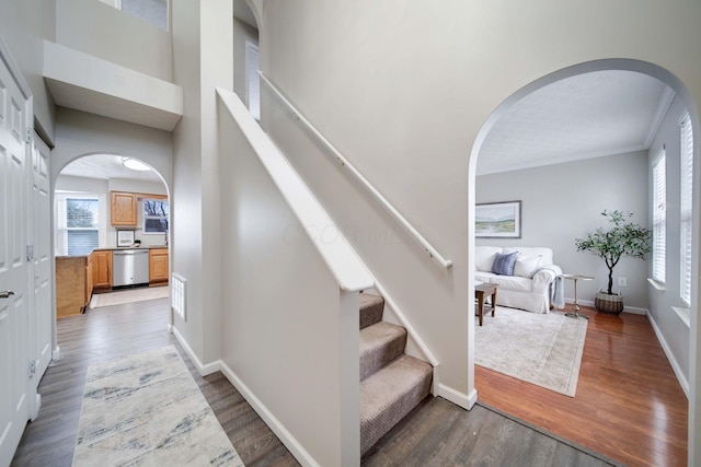 staircase with hardwood / wood-style flooring