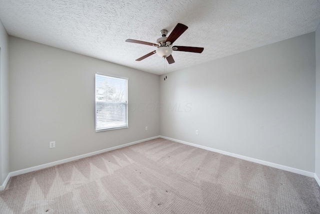 empty room with light carpet, ceiling fan, and a textured ceiling