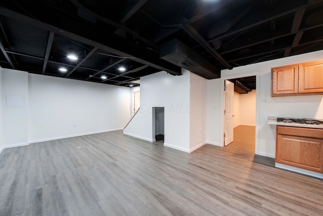 basement with light hardwood / wood-style flooring