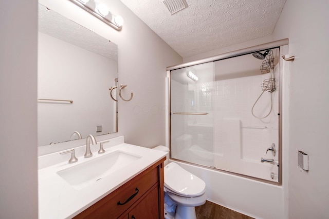 full bathroom featuring wood-type flooring, enclosed tub / shower combo, vanity, toilet, and a textured ceiling