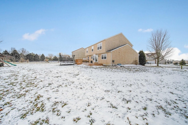 snow covered property featuring a trampoline