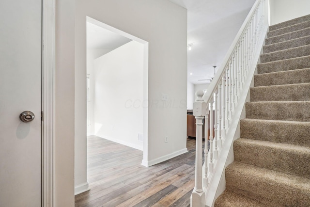 stairs featuring wood-type flooring