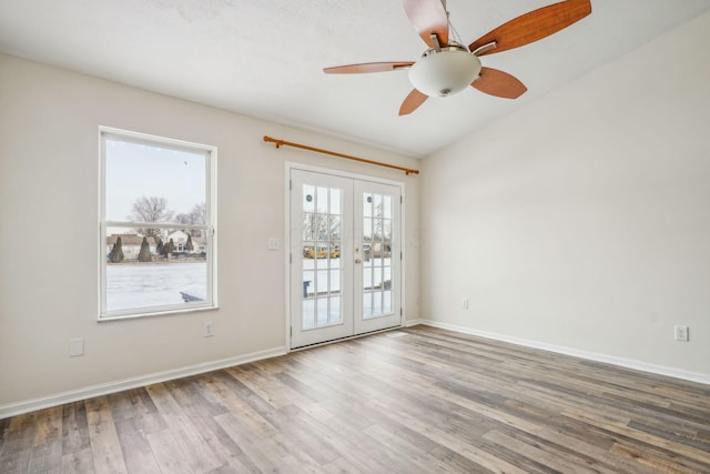 unfurnished room featuring hardwood / wood-style floors, french doors, and ceiling fan